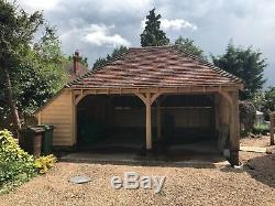 Two Bay Green Oak Fronted Catslide Garage with integrated log-store. 5.6m x 5.3m
